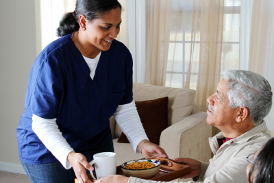 caregiver serving meal to a senior